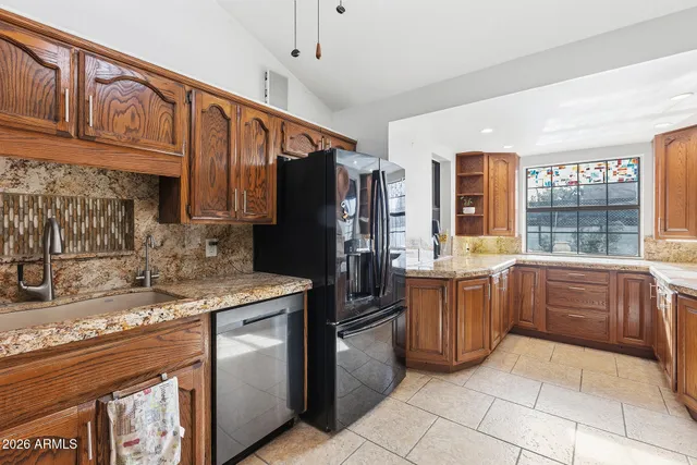 a kitchen with a sink stove and refrigerator