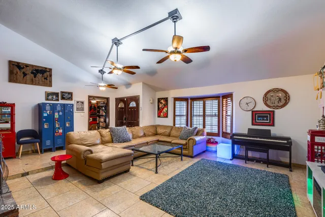 a living room with furniture a window and a flat screen tv