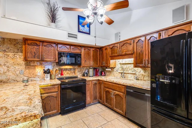 a kitchen with stainless steel appliances granite countertop a sink and cabinets