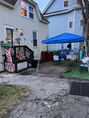 a view of a house with backyard and sitting area