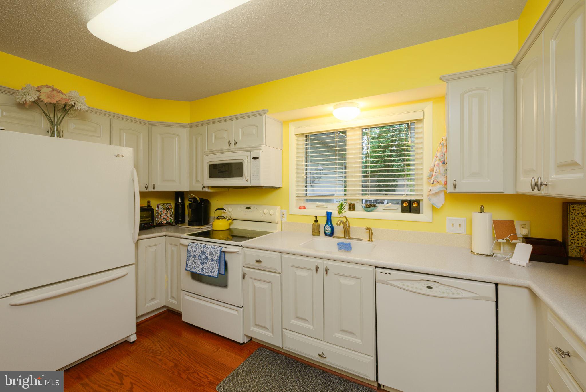10 Gloucester Road Ocean Pines, MD 21811 - Photo 14 of 37 a kitchen with white cabinets and white appliances