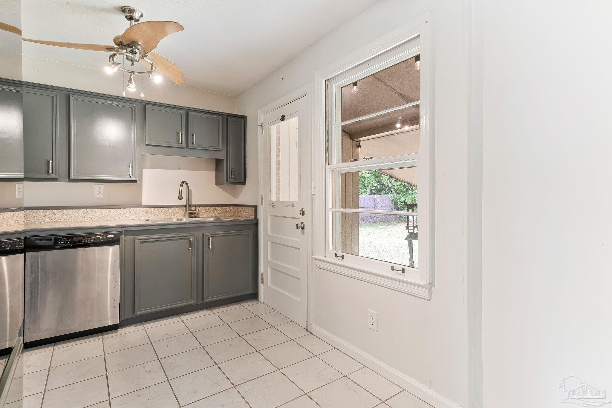 629 Rue Max Street Pensacola, FL 32507 - Photo 13 of 28 a kitchen with a sink cabinets and window