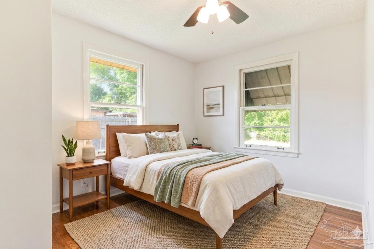 629 Rue Max Street Pensacola, FL 32507 - Photo 14 of 28 a bedroom with a bed lamp and a window