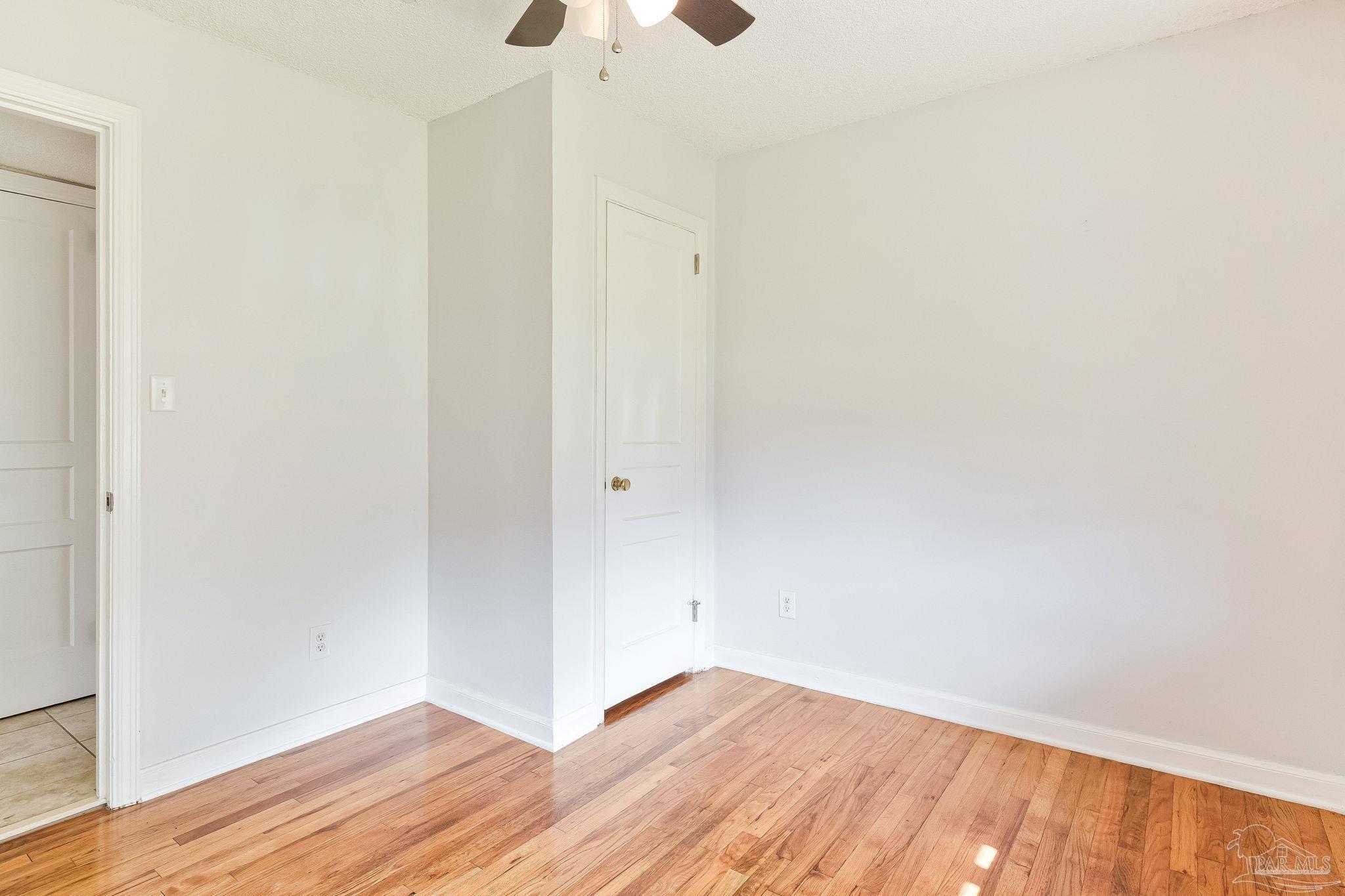 629 Rue Max Street Pensacola, FL 32507 - Photo 20 of 28 a view of an empty room with wooden floor