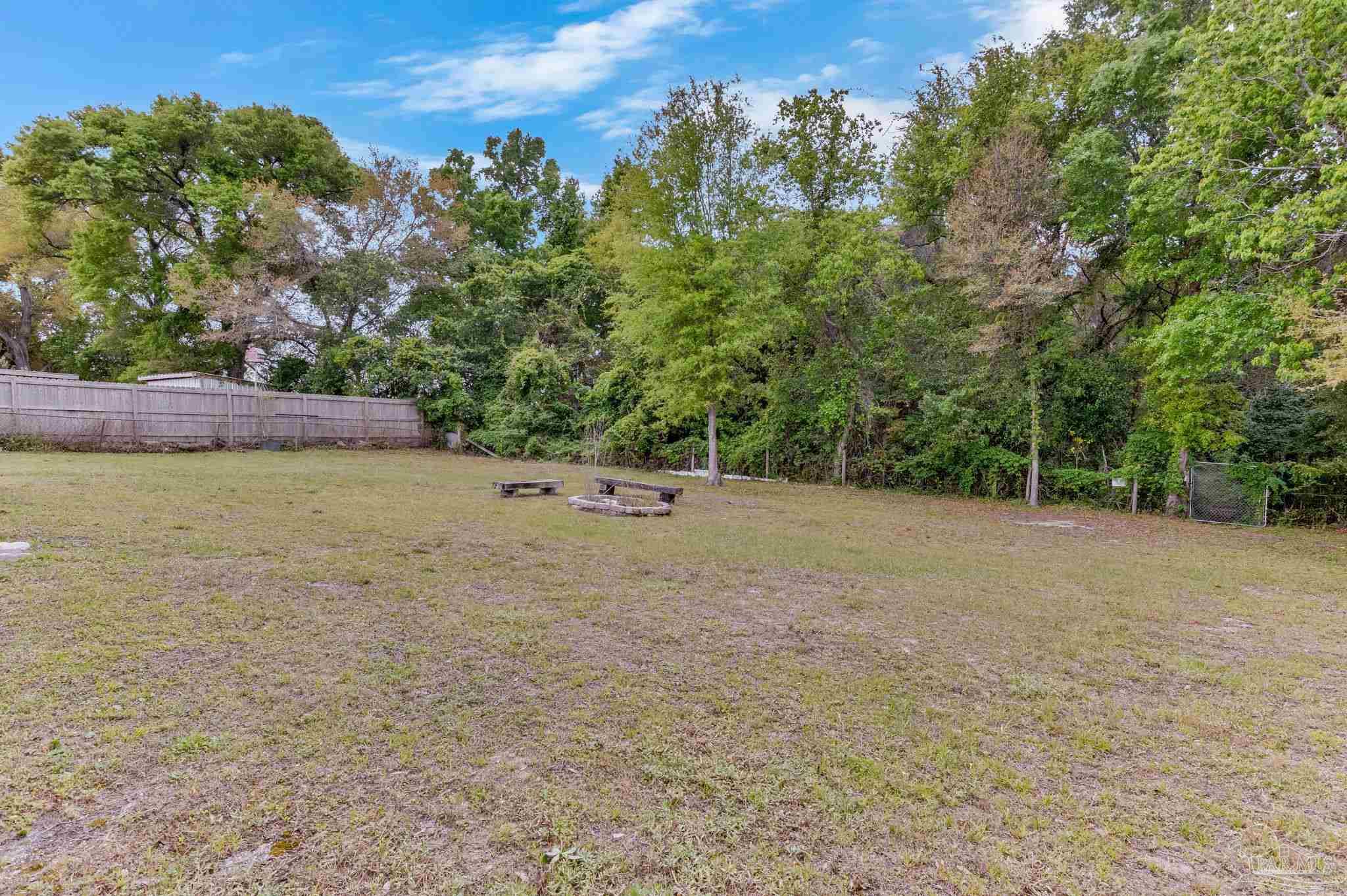 629 Rue Max Street Pensacola, FL 32507 - Photo 24 of 28 a view of a field with trees in the background