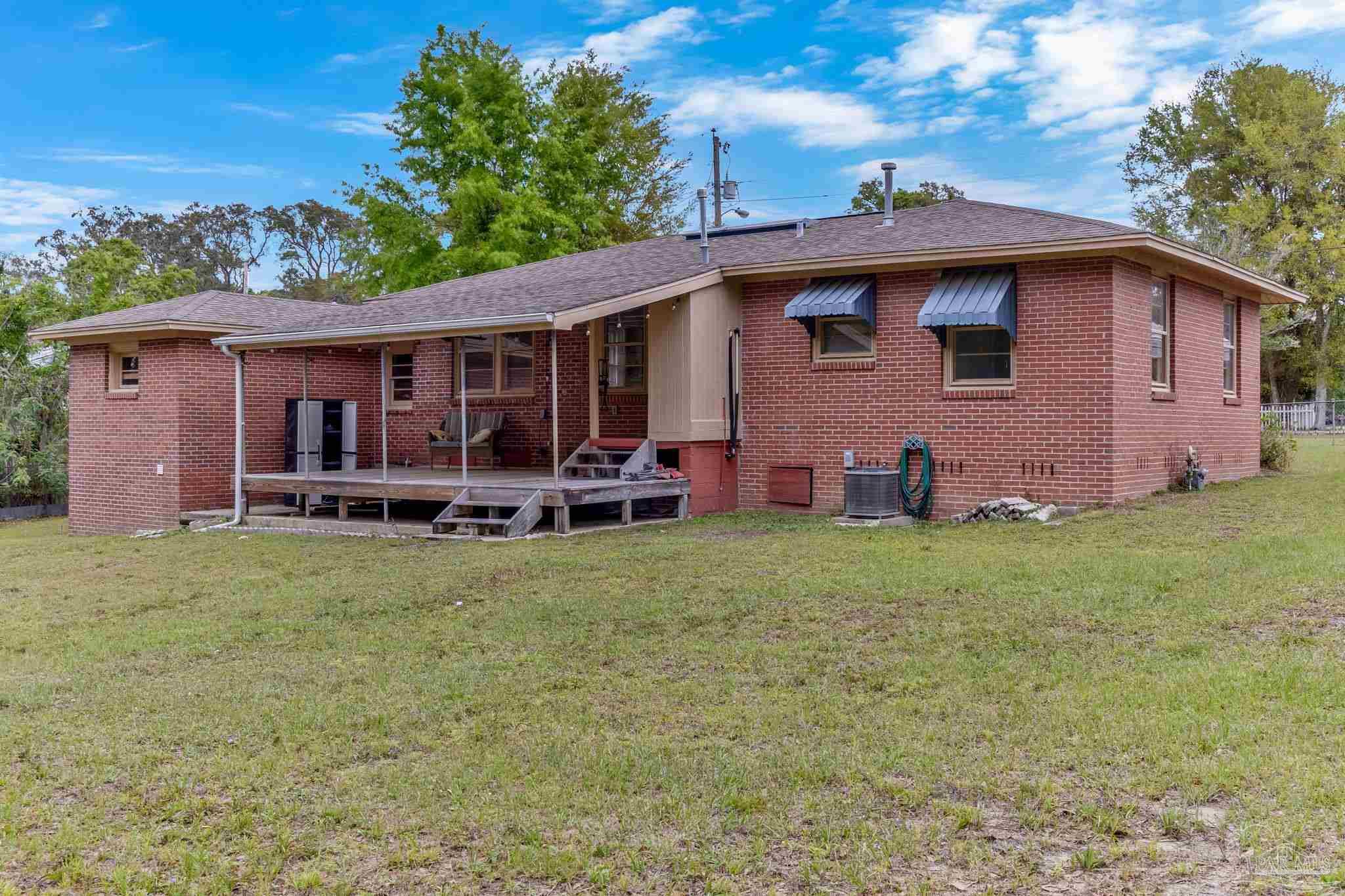 629 Rue Max Street Pensacola, FL 32507 - Photo 27 of 28 a view of a house with backyard and porch
