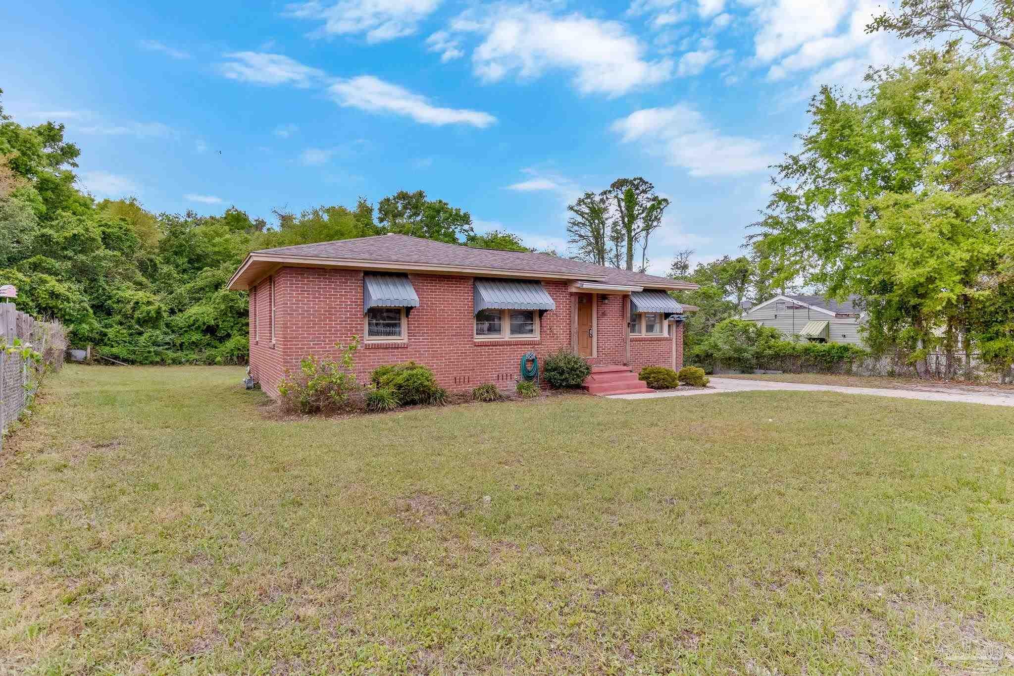 629 Rue Max Street Pensacola, FL 32507 - Photo 28 of 28 a front view of a house with a garden