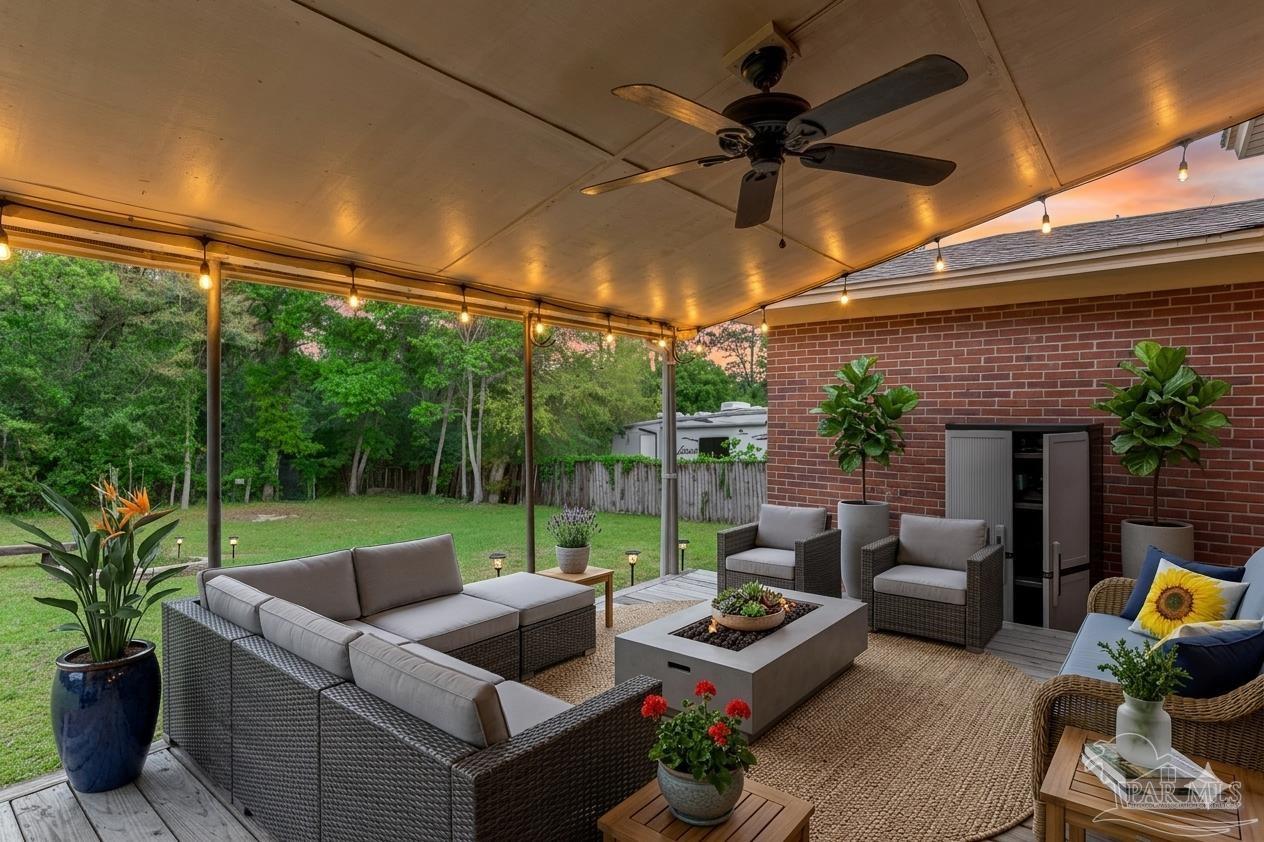 629 Rue Max Street Pensacola, FL 32507 - Photo 8 of 28 a backyard of a house with yard table and chairs