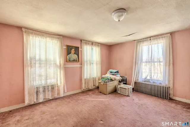 an aerial view of a house with a yard and green space