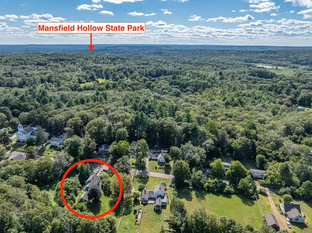 a bedroom with furniture and a chandelier