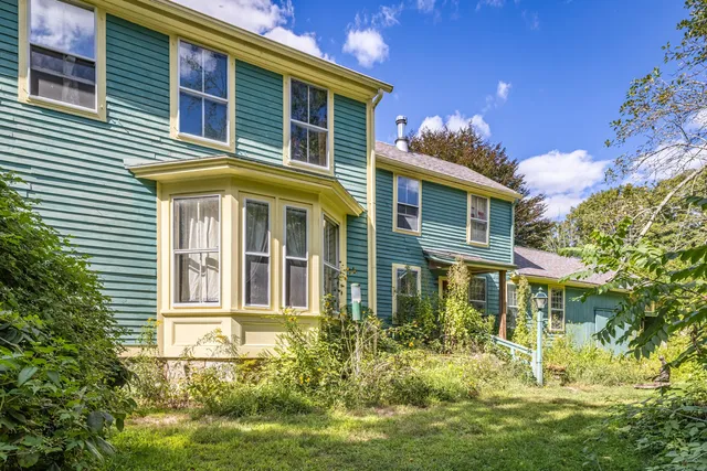 an aerial view of residential house with outdoor space and swimming pool