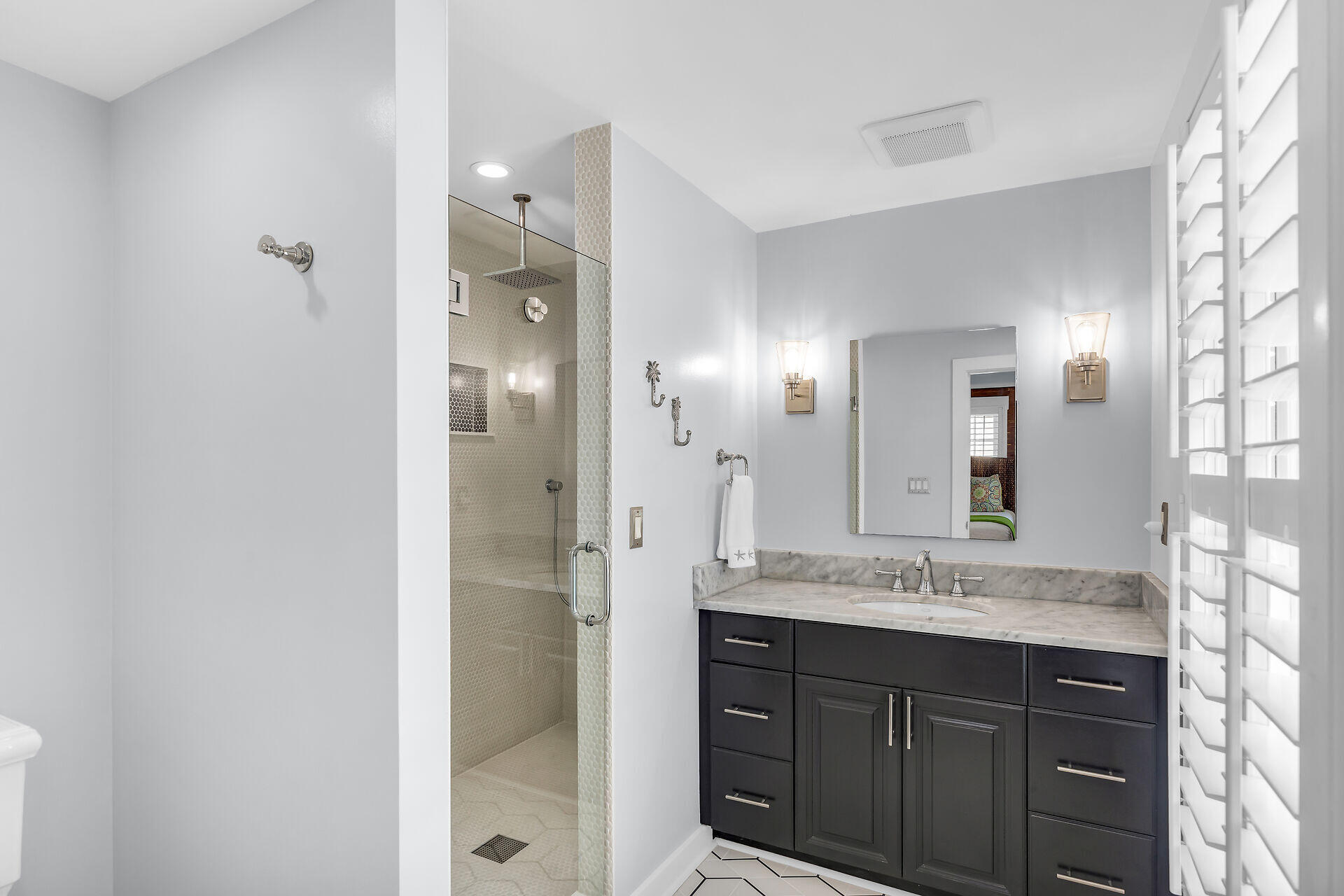 717 Southard Street Key West, FL 33040 - Photo 27 of 36 a bathroom with a sink and a mirror