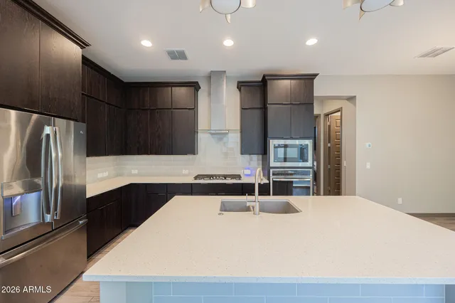 a kitchen with stainless steel appliances a refrigerator and a sink