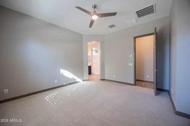 a view of an empty room with a ceiling fan