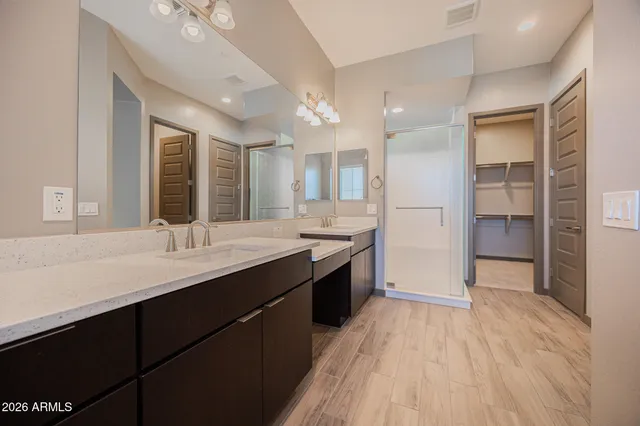 a large bathroom with a double vanity sink mirror and shower