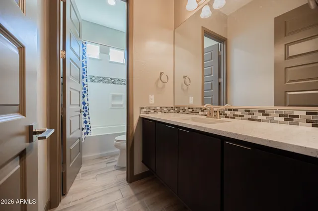 a bathroom with a double vanity sink and a mirror