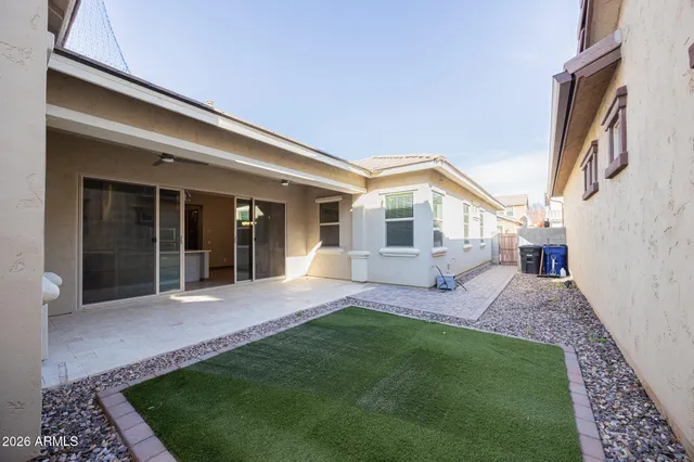 a view of a house with a yard and patio