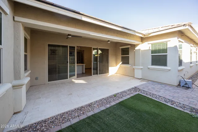 a view of a house with backyard and porch