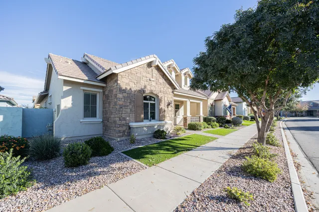 a front view of a house with a yard and porch