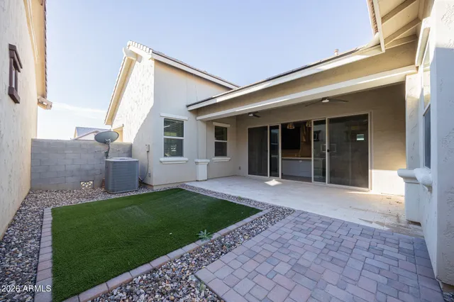a view of a house with a yard and large tree