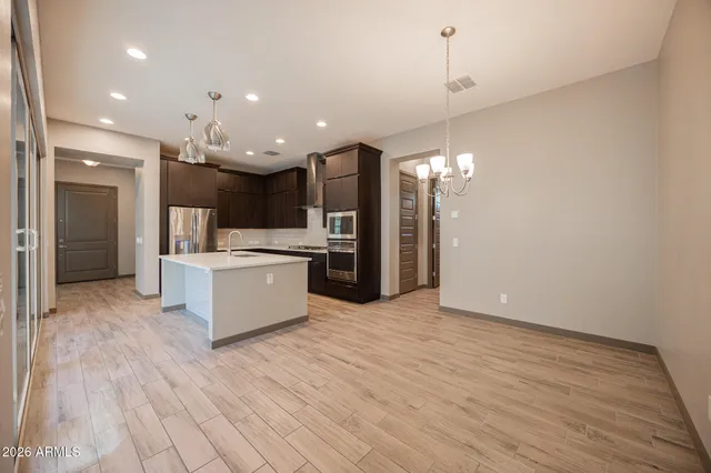 a large kitchen with kitchen island a sink stainless steel appliances and cabinets