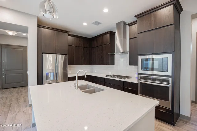 a kitchen with stainless steel appliances a refrigerator and a sink