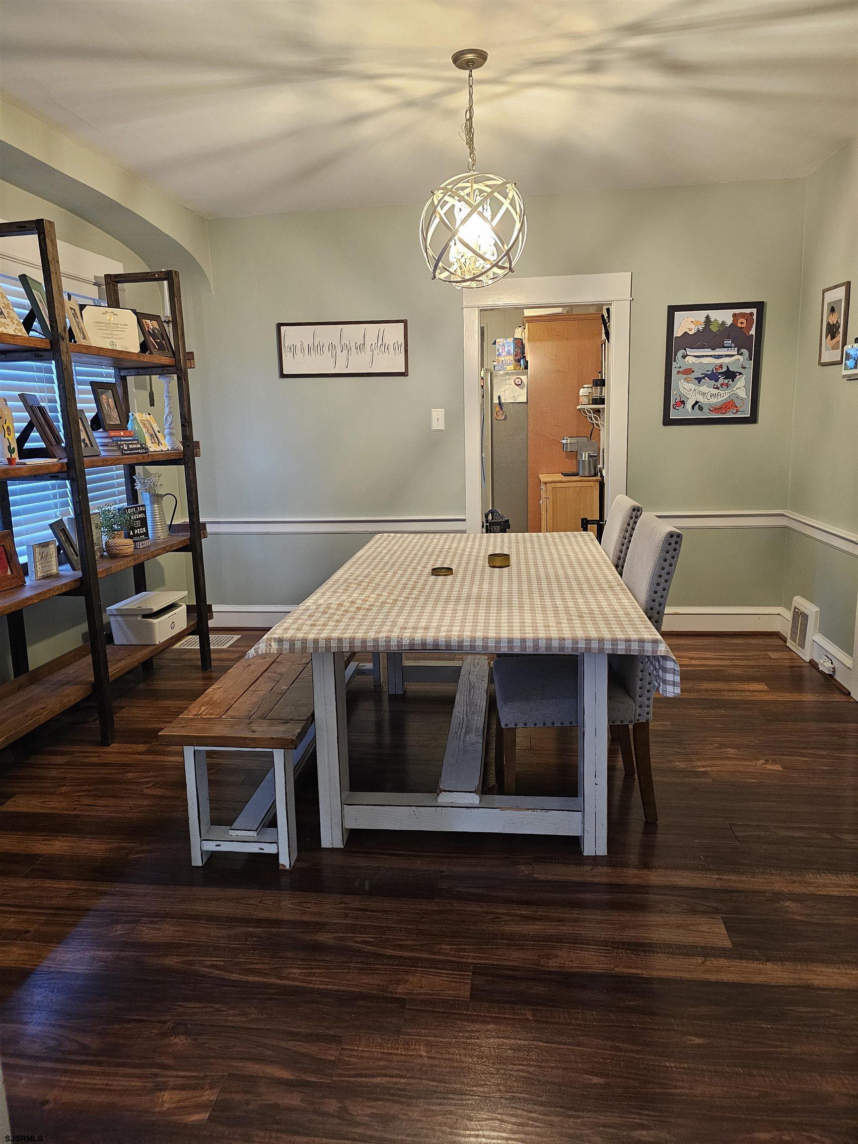 216 Marlin Road Absecon, NJ 08201 - Photo 11 of 20 a living room with a bed and a table with wooden floor