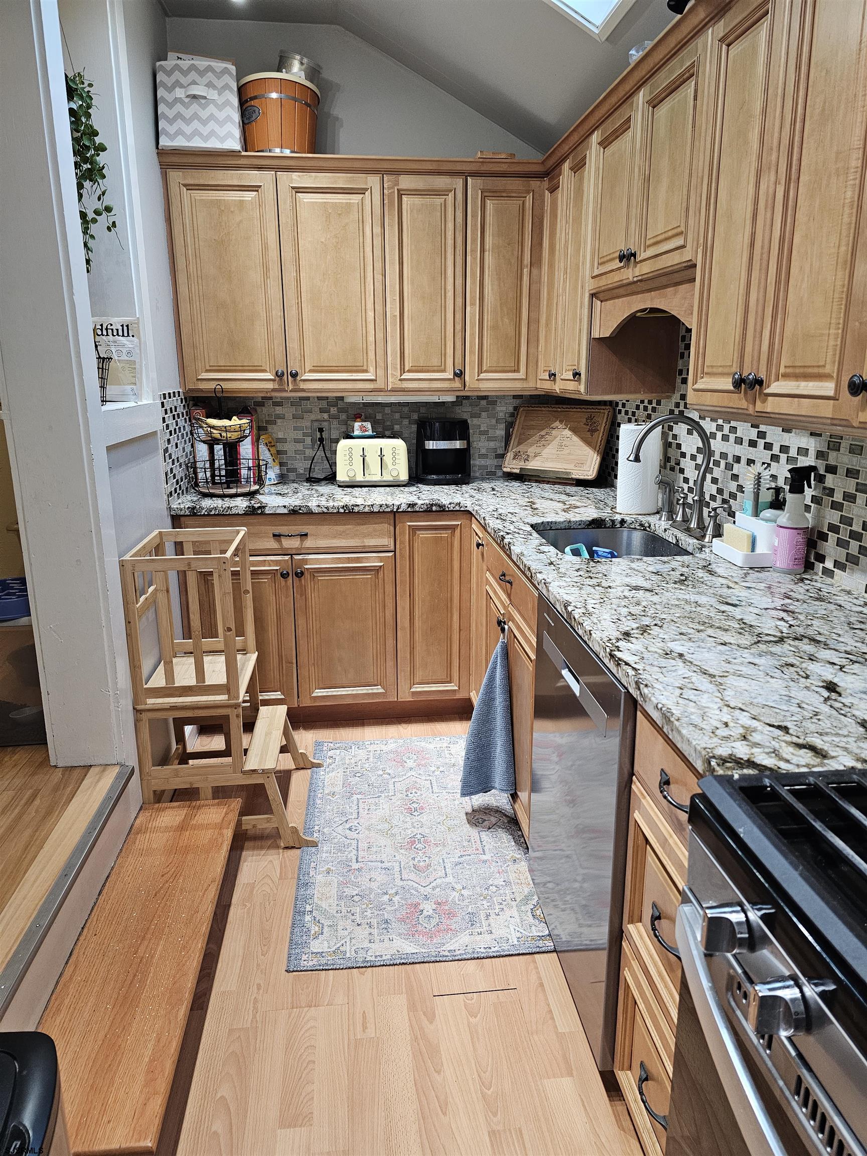 216 Marlin Road Absecon, NJ 08201 - Photo 8 of 20 a kitchen with stainless steel appliances granite countertop a stove a sink and a microwave