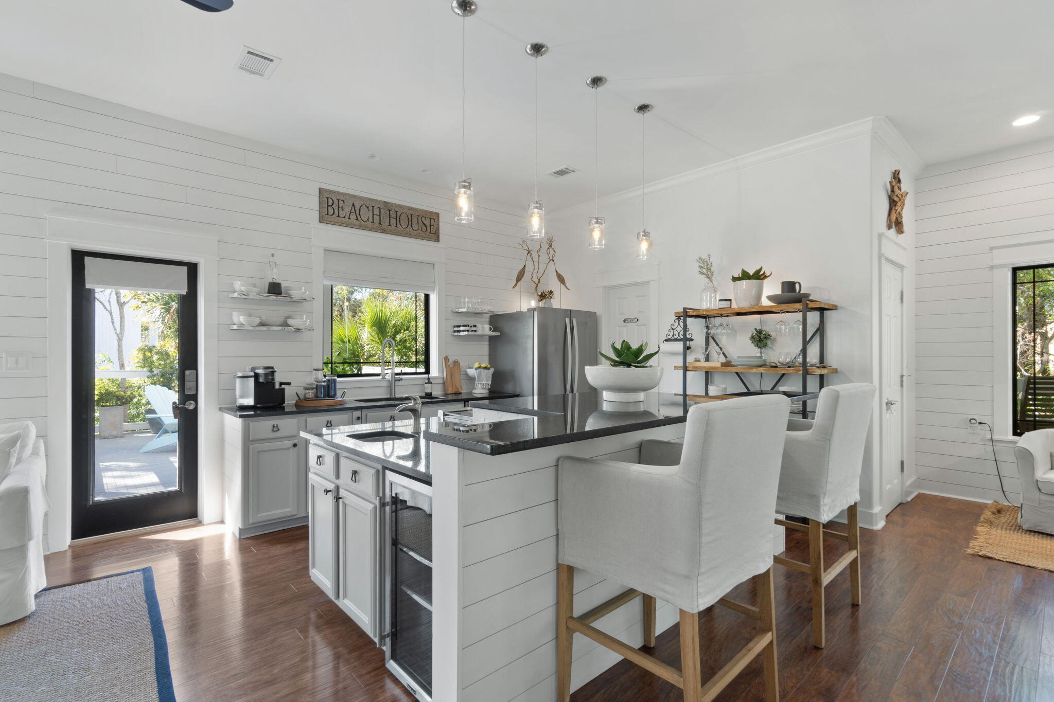 157 Baird Road Santa Rosa Beach, FL 32459 - Photo 22 of 93 a kitchen with stainless steel appliances granite countertop a stove top oven a sink a refrigerator and chairs