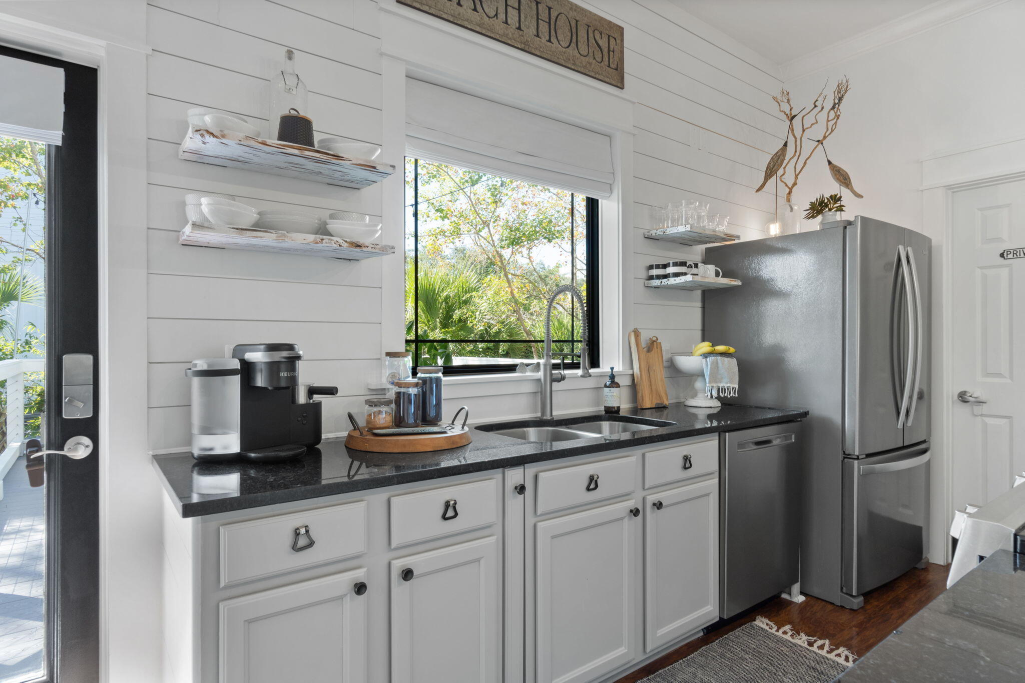 157 Baird Road Santa Rosa Beach, FL 32459 - Photo 26 of 93 a kitchen with stainless steel appliances a sink cabinets and a window
