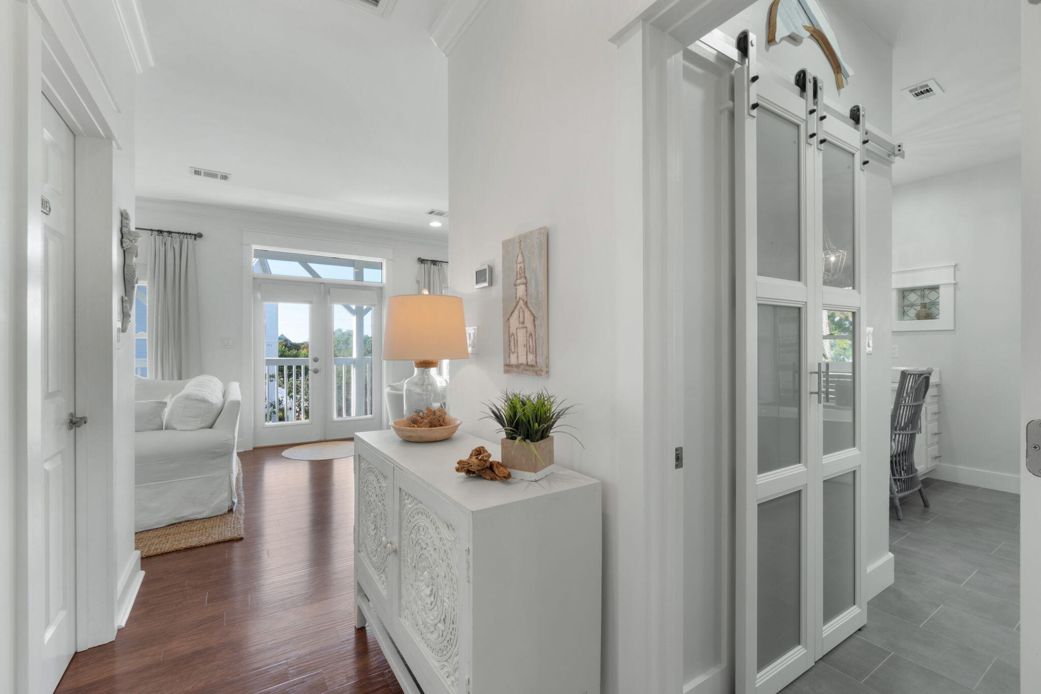 157 Baird Road Santa Rosa Beach, FL 32459 - Photo 46 of 93 a view of a hallway with wooden floor windows and a livingroom