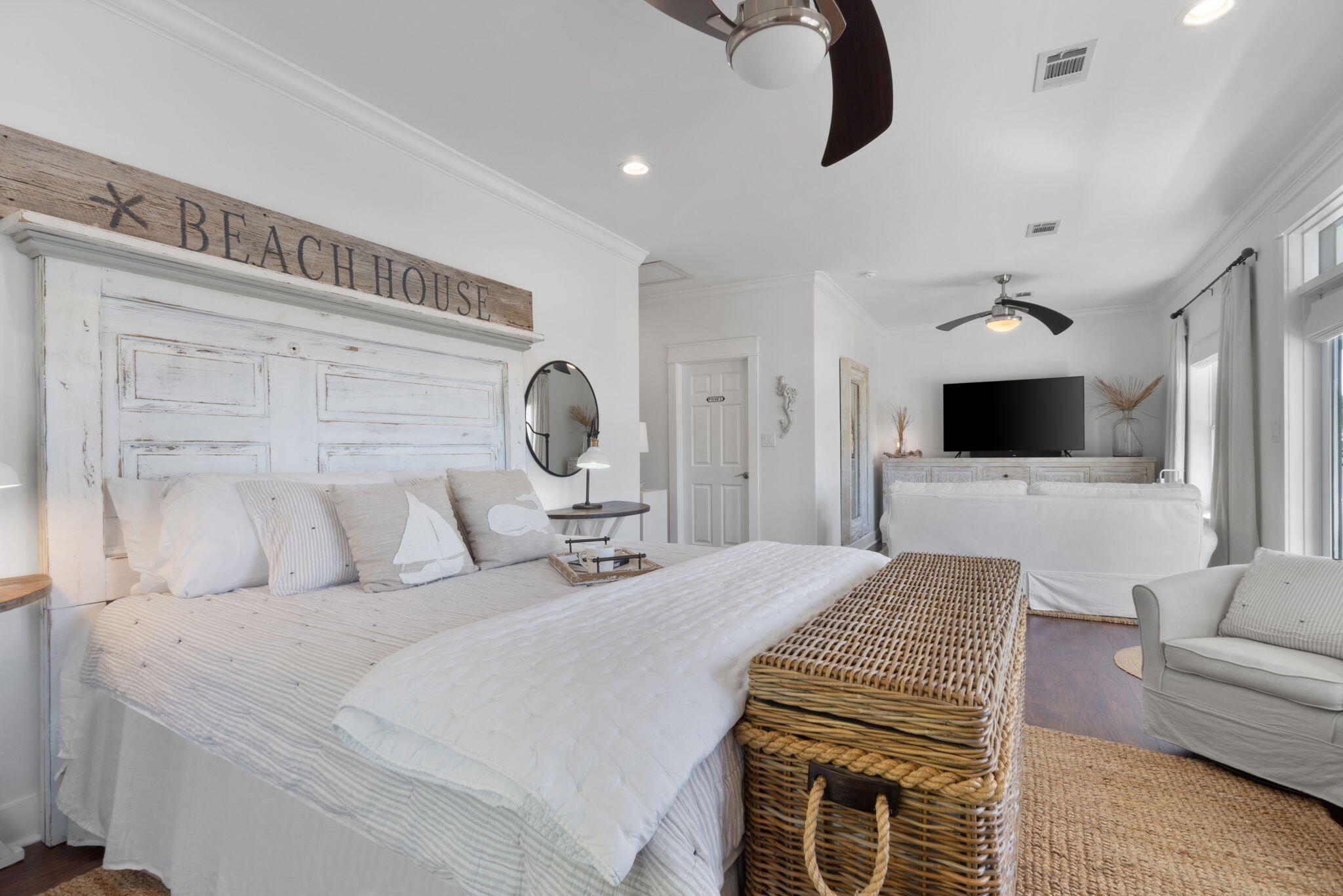 157 Baird Road Santa Rosa Beach, FL 32459 - Photo 49 of 93 a bedroom with a bed a couch and a flat screen tv