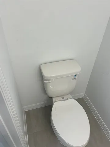 a white toilet sitting next to a white sink