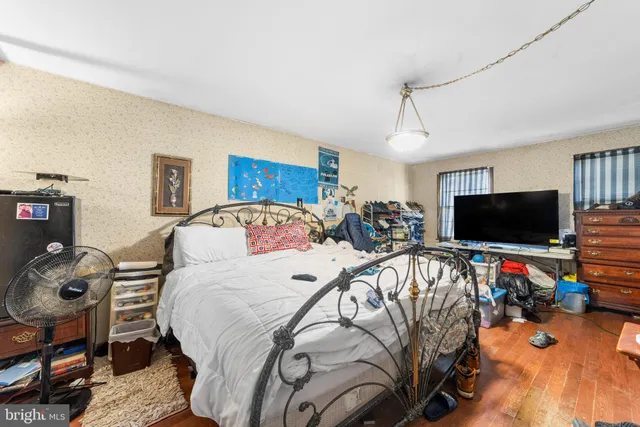 a bed room with a bed a television and a couch