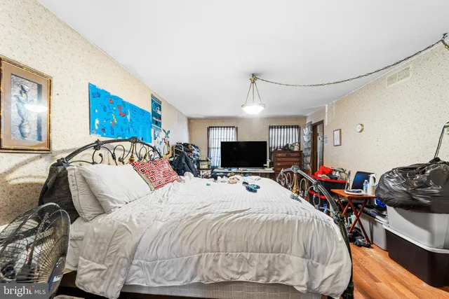 a bed room with a bed and a television