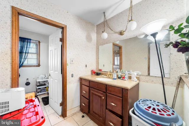 a bathroom with a sink mirror and vanity