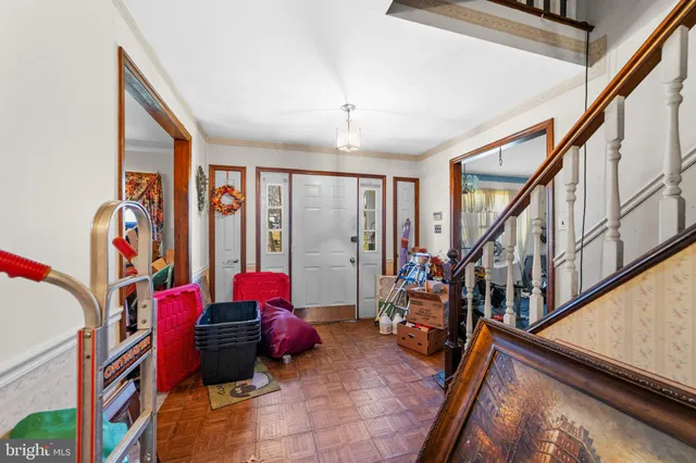 a living room with furniture flowers and a window