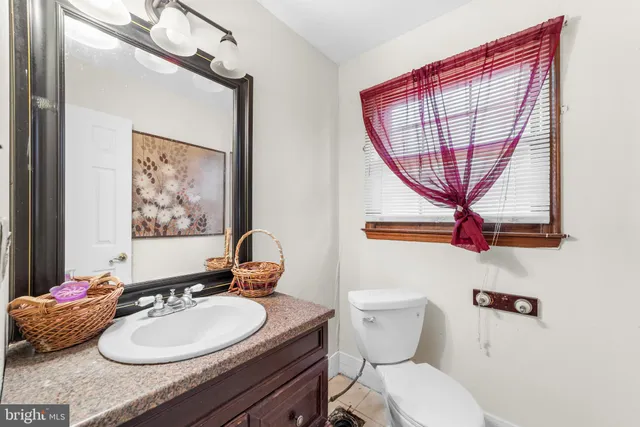 a bathroom with a sink a mirror and a toilet