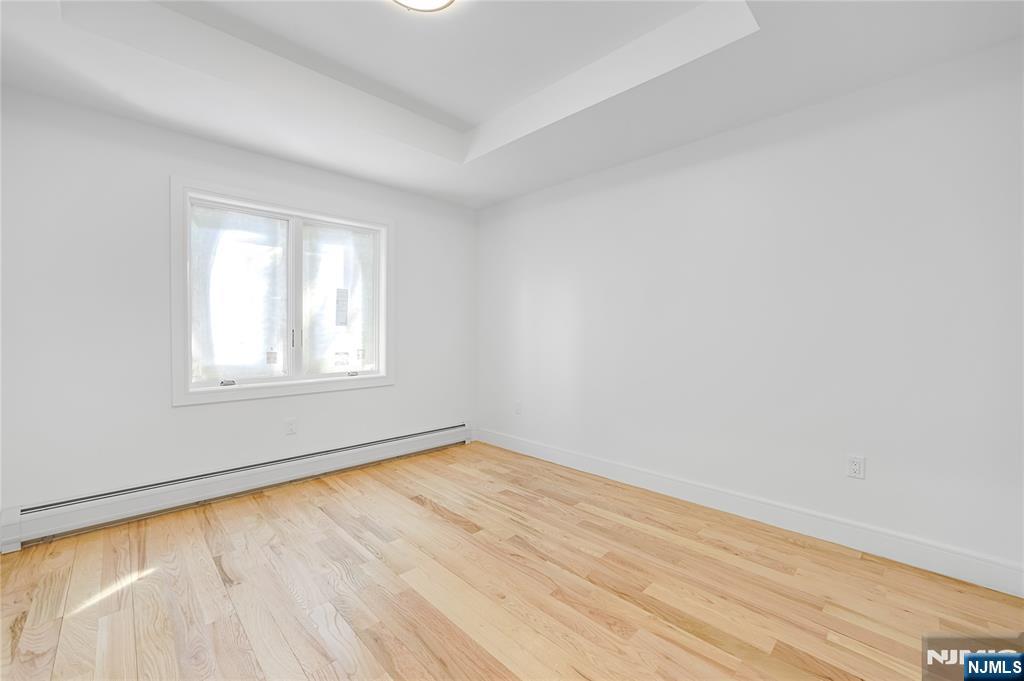 762 Williams Place, Unit A Cliffside Park, NJ 07010 - Photo 18 of 30 wooden floor in an empty room with a window