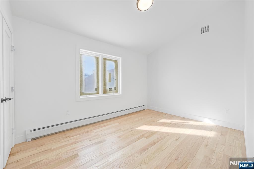 762 Williams Place, Unit A Cliffside Park, NJ 07010 - Photo 19 of 30 an empty room with a window