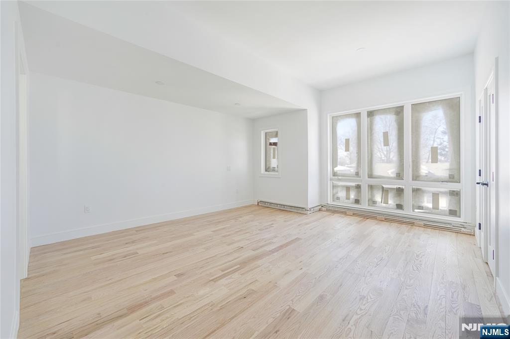 762 Williams Place, Unit A Cliffside Park, NJ 07010 - Photo 22 of 30 wooden floor in an empty room with a window