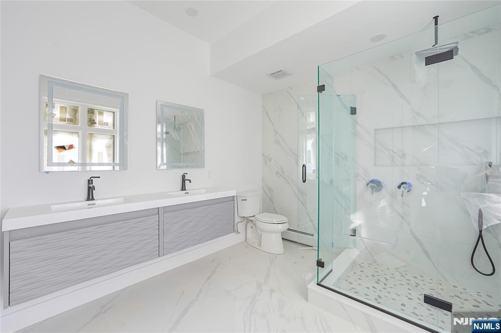 762 Williams Place, Unit A Cliffside Park, NJ 07010 - Photo 25 of 30 a spacious bathroom with a granite countertop sink mirror and a bathtub