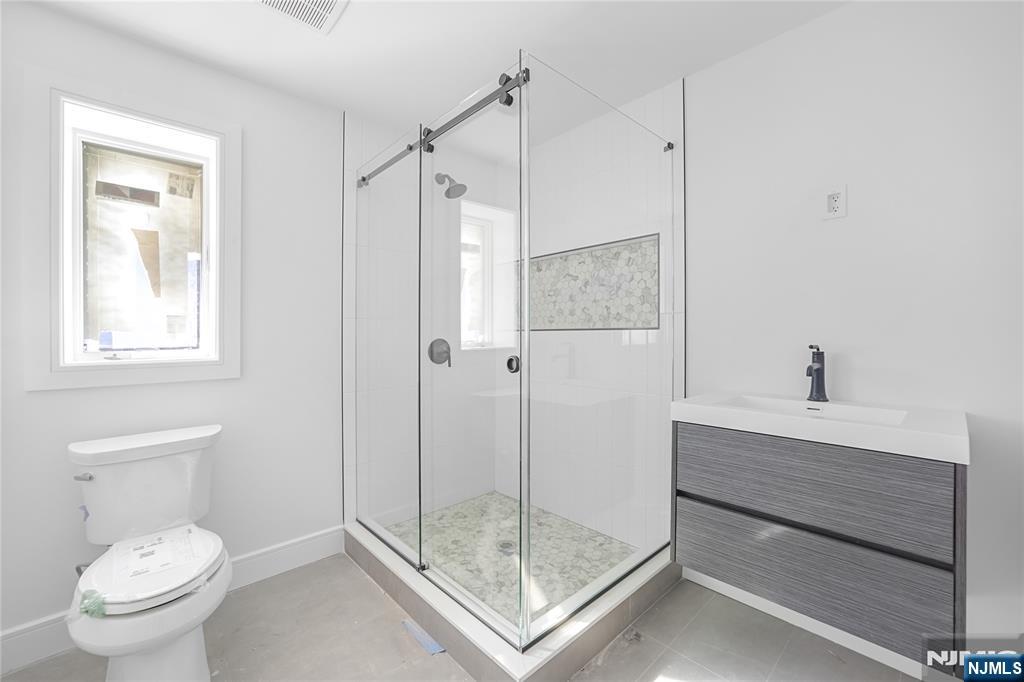 762 Williams Place, Unit A Cliffside Park, NJ 07010 - Photo 28 of 30 a bathroom with a shower a toilet and sink