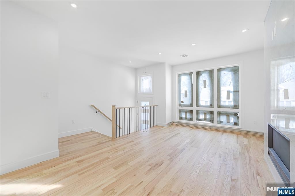 762 Williams Place, Unit A Cliffside Park, NJ 07010 - Photo 8 of 30 a view of an empty room with wooden floor and a window