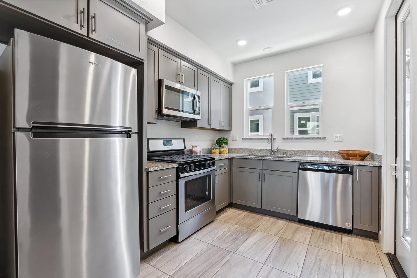 1488 Cherry Circle Milpitas, CA 95035 - Photo 7 of 20 a kitchen with granite countertop stainless steel appliances a refrigerator sink and microwave
