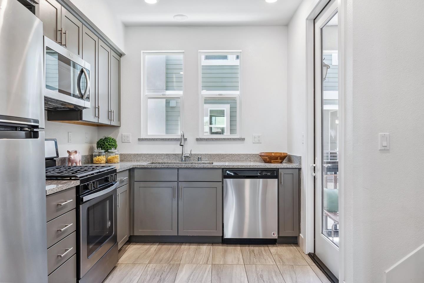 1488 Cherry Circle Milpitas, CA 95035 - Photo 9 of 20 a kitchen with stainless steel appliances granite countertop a stove a sink and a refrigerator