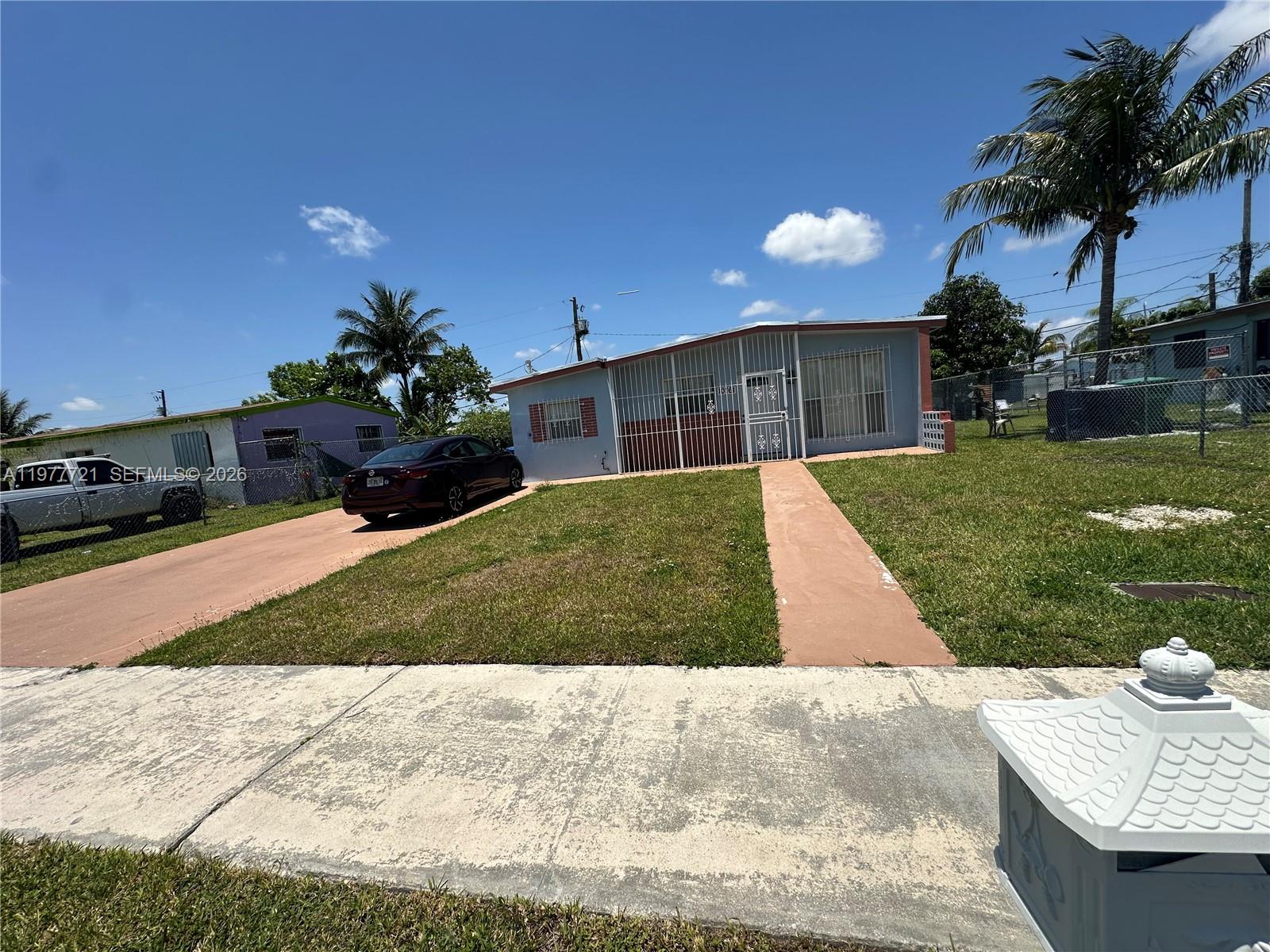 10761 Southwest 221st Street Miami, FL 33170 - Photo 1 of 32 a view of a backyard with table and chairs and potted plants