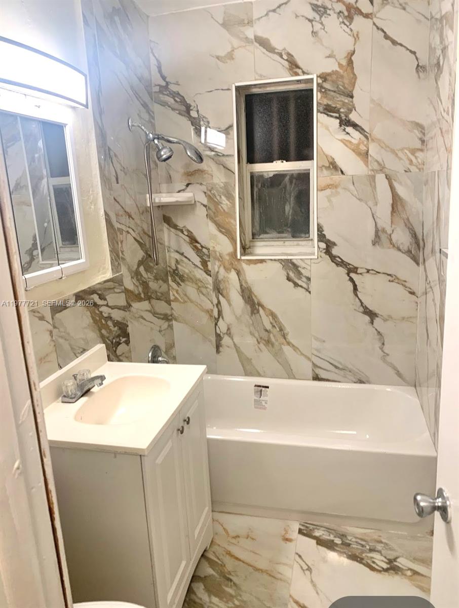 10761 Southwest 221st Street Miami, FL 33170 - Photo 11 of 32 a bathroom with a bathtub and a shower