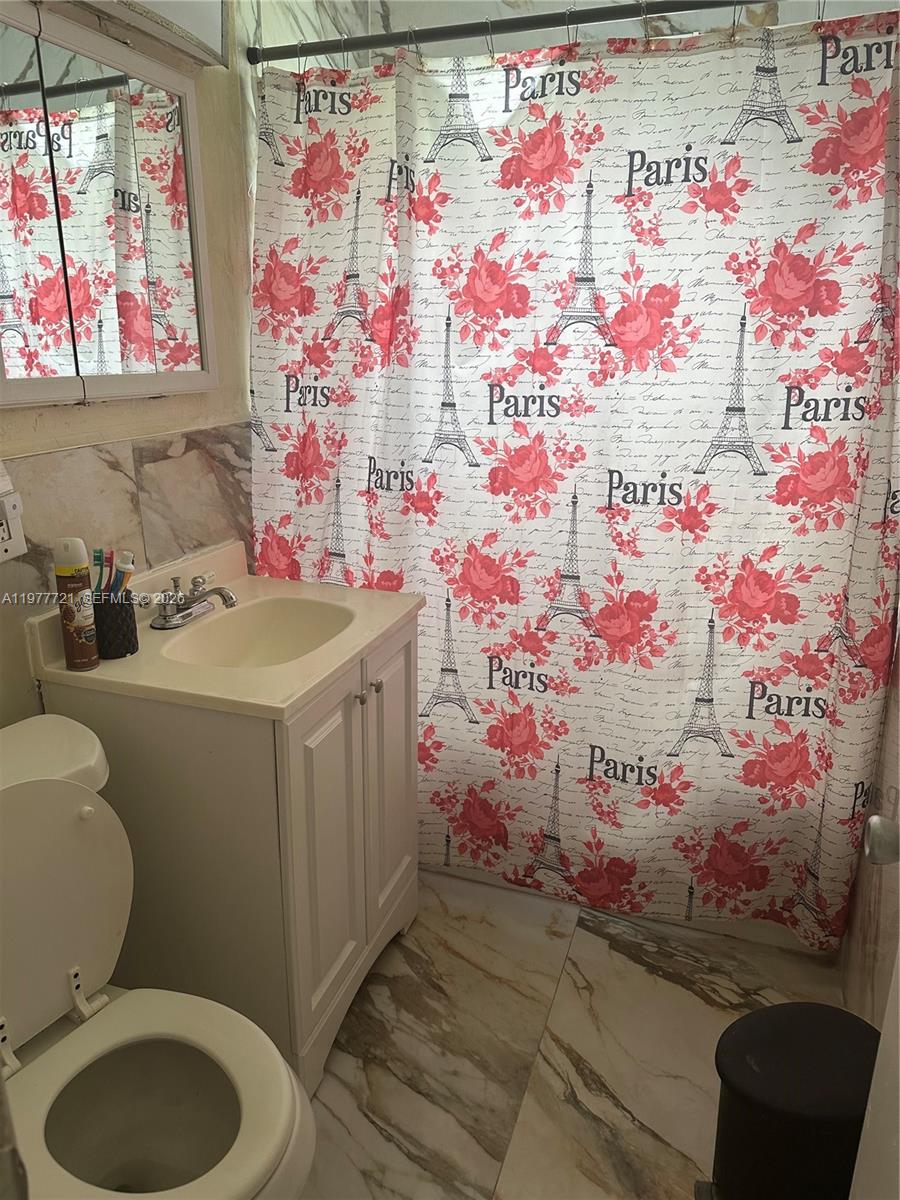 10761 Southwest 221st Street Miami, FL 33170 - Photo 12 of 32 a bathroom with a sink toilet and window