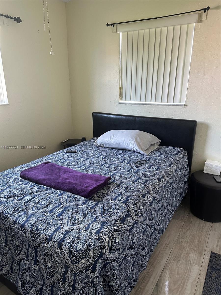 10761 Southwest 221st Street Miami, FL 33170 - Photo 16 of 32 a bedroom with a bed and a window